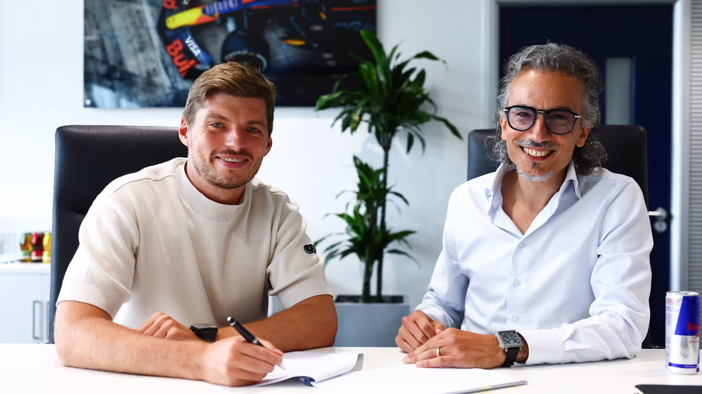 Max Verstappen signing a contract with Red Bull (Image via Formula 1 Corporation)