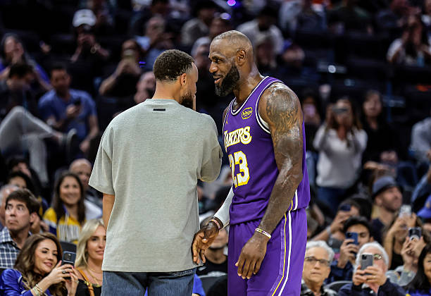 LeBron James (23) stops to chat with Stephen Curry (30)