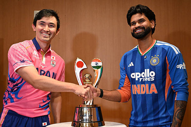 India vs Japan: India's captain Shreyas Iyer (R) shakes hands with Japanese captain Kendel Kadowaki-Fleming during a press conference ahead of their T20 cricket match, in Tokyo on September 21, 2026. (Photo by Rie KIKUCHI / AFP via Getty Images)