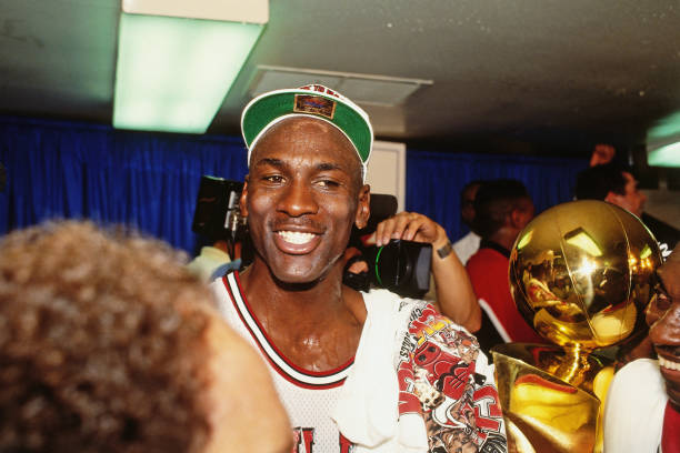 NBA GOAT Michael Jordan #23 of the Chicago Bulls celebrates with the Larry O'Brien Trophy