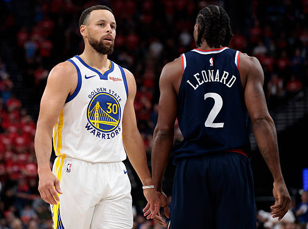 Stephen Curry #30 of the Golden State Warriors walks on court past Kawhi Leonard #2 of the Los Angeles Clippers
