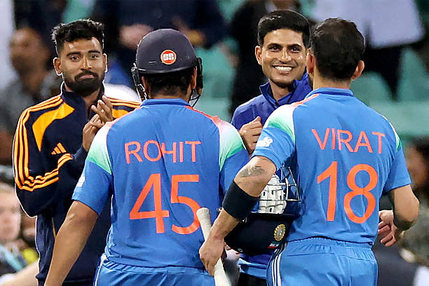 India's Rohit Sharma and Virat Kohli are congratulated by India's captain Shubman Gill (2R)
